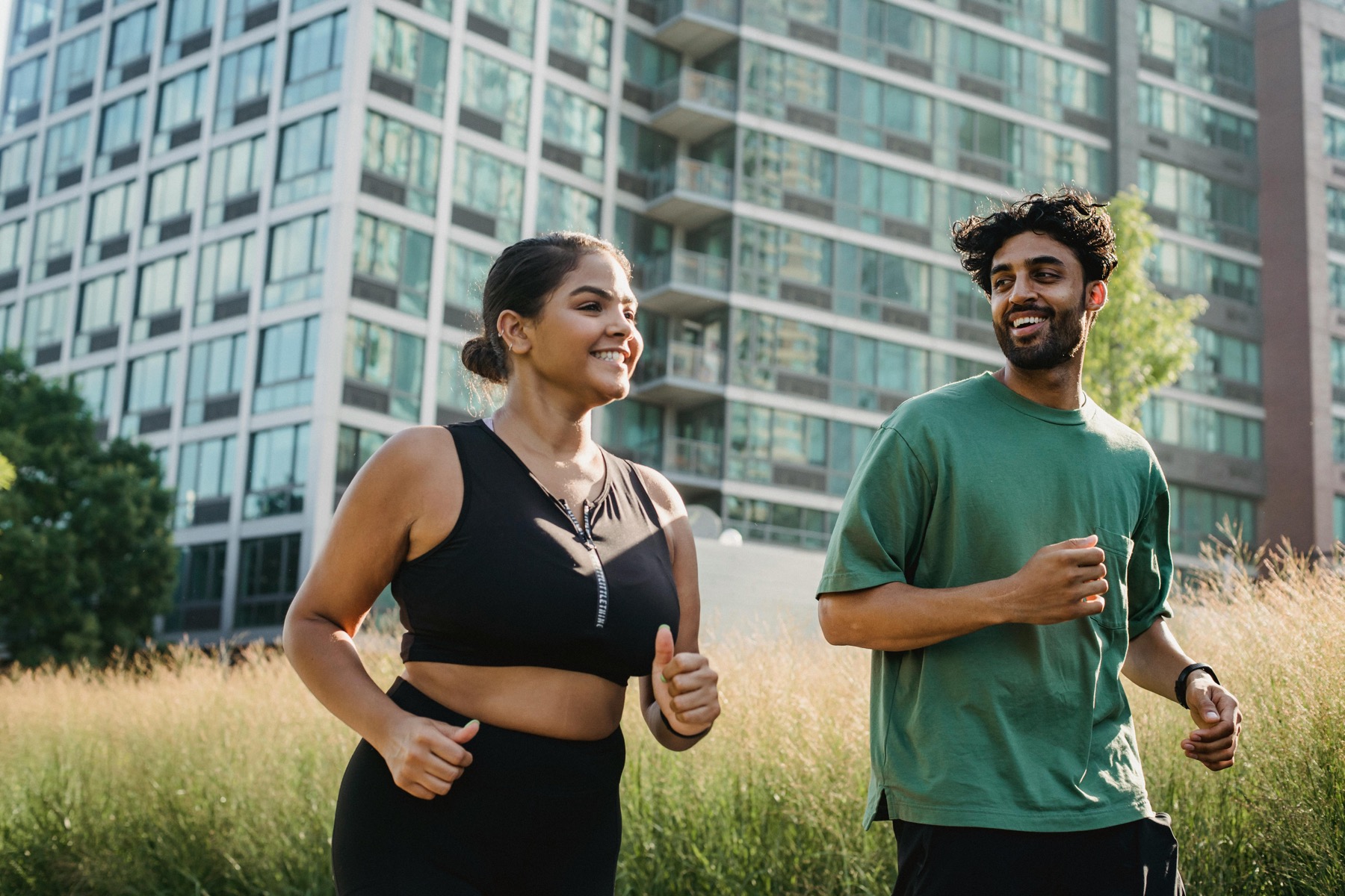Two people running together showing partnership
